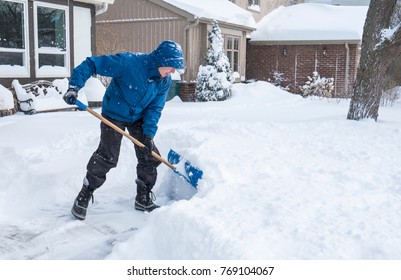 Man Removal Snow With A Shovel