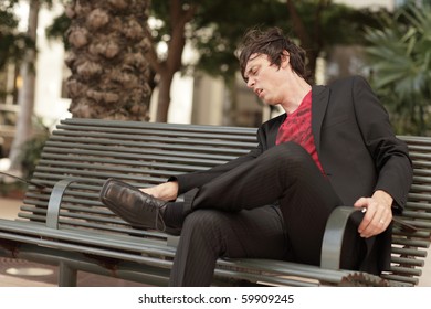 Man Removing Gum Which Is Stuck To His Shoe