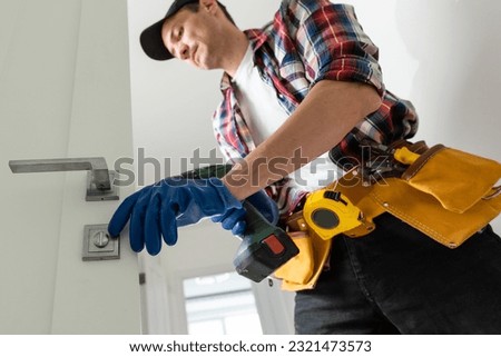 Man removing lock from door 