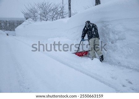 A man is removing snow.