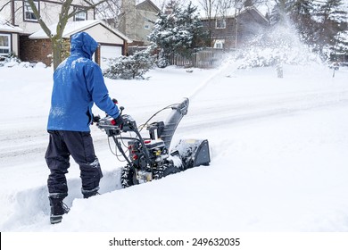 Man Removing Snow with a Snow Blower