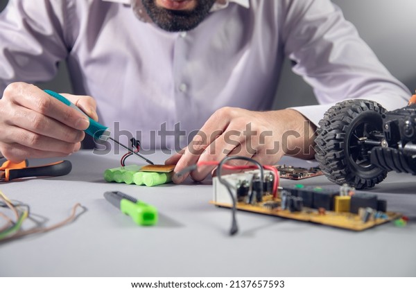 Man  repair of a battery car\
toy