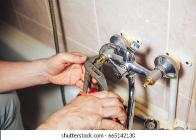 Man Repair And Fixing Leaky Faucet In Bathroom