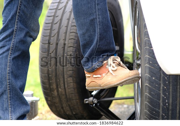 Man repaired\
wheeled vehicles on the road, Replacing winter and summer tires.\
Seasonal tire replacement\
concept