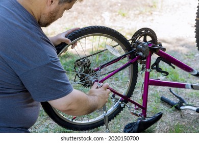 Man Repairing Bicycles A Handsome Bike Mechanic In Working Process