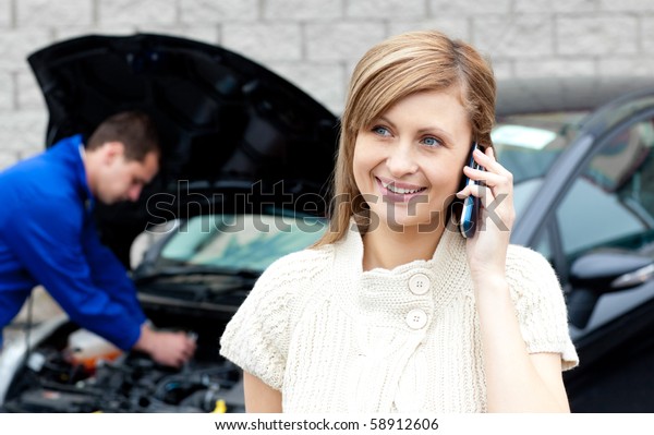 Man repairing black car\
of busy woman