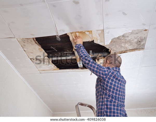 Man Repairing Collapsed Ceiling Ceiling Panels Stock Photo