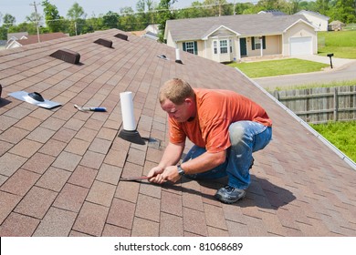 Man Repairing Damage To Shingles After Strong Storm Came Through And Water Was Coming Down Into Home