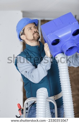 man repairing electrical wiring box
