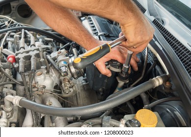 Man repairing engine of the car
