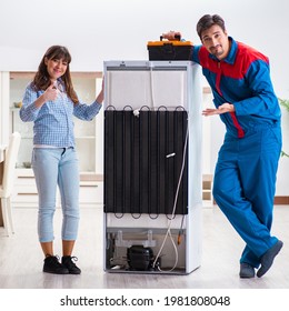 Man Repairing Fridge With Customer