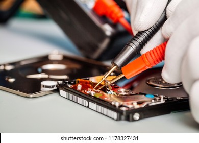 Man Repairing Hard Drive In Service Center. Repairing And Fixing Service In Lab. Electronics Repair Service Concept.