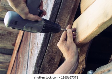 man repairing a house. screwdriver