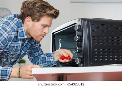 Man Repairing Microwave