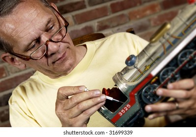 Man Repairing Model Train