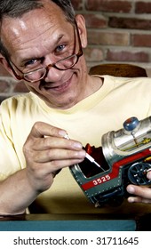 Man Repairing Model Train