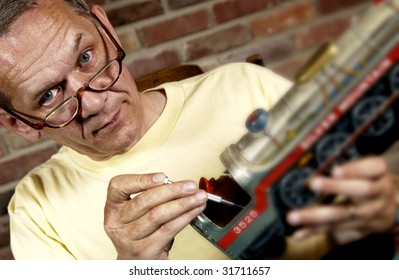 Man Repairing Model Train