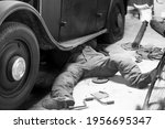 Man repairing old vintage front-wheel drive car