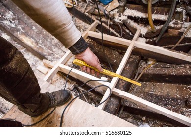 Man  repairing old wooden fishing boat.  - Powered by Shutterstock