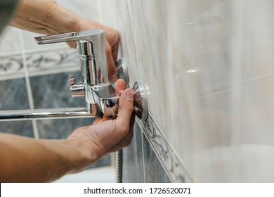 A Man Repairs A Broken Faucet