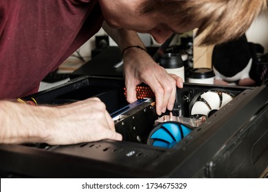 Man repairs a computer system unit, changes parts, video card and hard drive. Computer Repair Wizard.