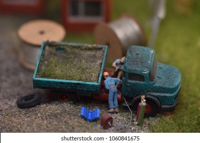a man repairs a truck,plastic toy at Exhibition of electric trains in Bistrita,martie 2018 - Shutterstock ID 1060841675