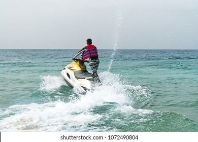 Man Rescue On A Water Motorcycle On The Sea. Unidentified Black Male View From Behind. Indian Ocean, Andaman Sea