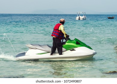 Man Rescue On A Water Motorcycle On The Sea. Unidentified Black Male View From Behind. Indian Ocean, Andaman Sea