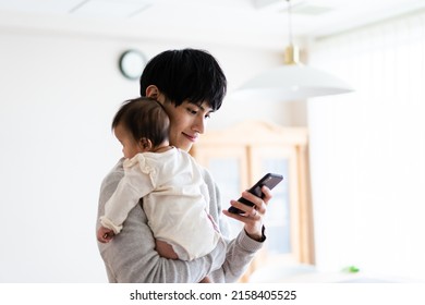 A Man Researching Childcare On His Smartphone