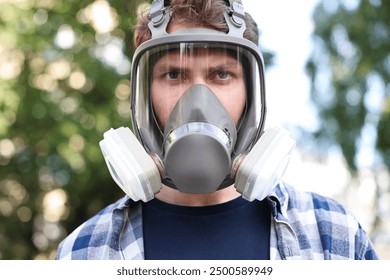 Man in respirator mask outdoors. Safety equipment - Powered by Shutterstock