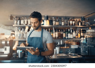 Man in restaurant, tablet and inventory check, small business and entrepreneur in hospitality industry. Male owner, scroll and cafe franchise, digital admin and stock taking with connectivity
