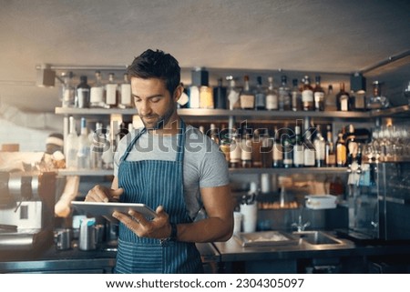 Man in restaurant, tablet and inventory check, small business and entrepreneur in hospitality industry. Male owner, scroll and cafe franchise, digital admin and stock taking with connectivity