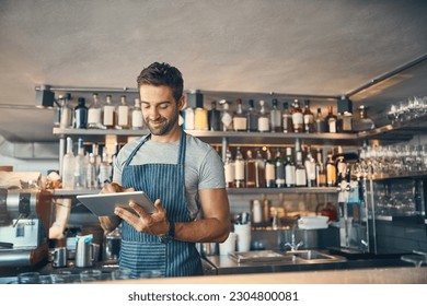 Man in restaurant, tablet and small business with inventory check, entrepreneur in hospitality industry and connectivity. Male owner, scroll and cafe franchise with digital admin and stock taking