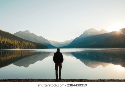 A man is resting at ease by the calm lake. Relaxation vacation