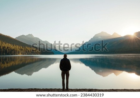 A man is resting at ease by the calm lake. Relaxation vacation