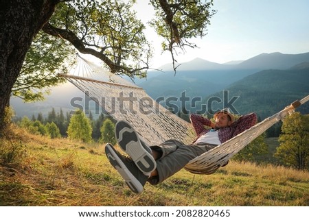 Man resting in hammock outdoors at sunset Сток-фото © 