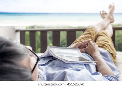 Man Resting To Relax On The Sofa Bad In Beach Resort. Take A Break On Weekend. Travel And Relaxing Concept. Selective Focus.