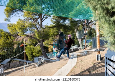 A Man Is Resting In A Rope Amusement Park. Front View.