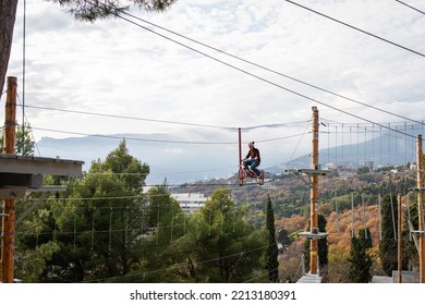 A Man Is Resting In A Rope Amusement Park. Front View.