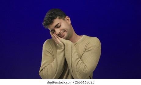 Man rests cheek while sleeping against background featuring young hispanic colored male face sleep posture.