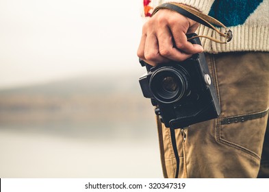 Man With Retro Photo Camera Fashion Travel Lifestyle Outdoor Foggy Nature On Background