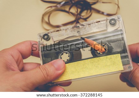 man rewind a cassette tape - vintage style