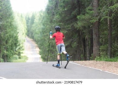 Man Ride Roller Skis In The Autumn Park.