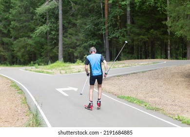 Man Ride Roller Skis In The Autumn Park.