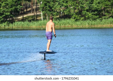 A Man Rides A Hydrofoil On The Lake