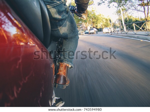 Man rides a\
motorcycle through Madrid,\
Spain.
