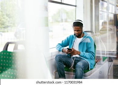 Man Riding In Bus Listening Music In Headphones - Powered by Shutterstock