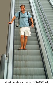 a man riding down an escalator