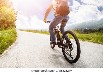 Man Riding Electric Mountain Bike In Alps