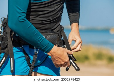 Man riding a kiteboard on calm water under a sunny sky, showcasing the thrill of extreme water sports - Powered by Shutterstock